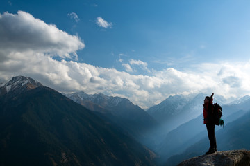 Climbing young adult at the top of summit