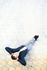 Businessman sitting at the street