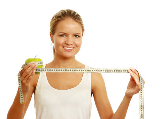 Young dietician pointing towards apple and measuring tape