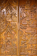 Native Thai style carving, painting on church door in the temple