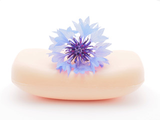 cornflowers and soap on a white background