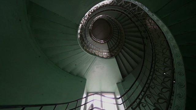 Grunge, green spiral staircase in old, abandoned building
