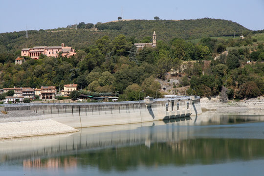 dam with Lake below and an old church on the Hill