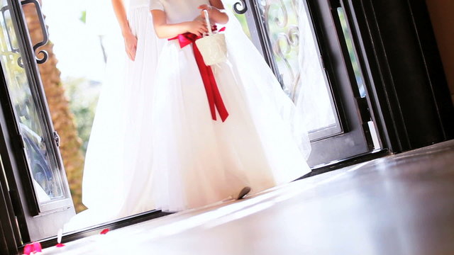 Flower Girl Scattering Petals Before Bride