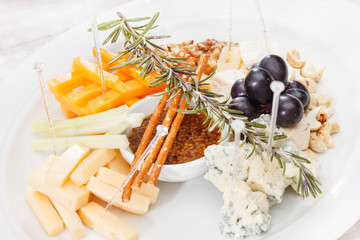 Cheese plate with grapes and honey
