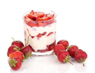 Glass of ripe strawberries with cream isolated on white