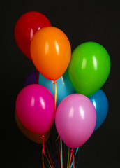 Fototapeta na wymiar colorful balloons on black background close-up