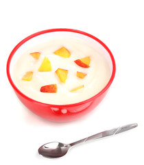 Yoghurt with peach in bowl isolated on white