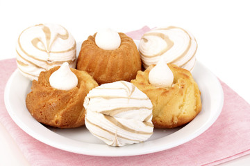 Appetizing cupcakes with cream isolated on white