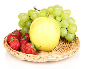 ripe sweet fruits and berries on wicker mat isolated on white