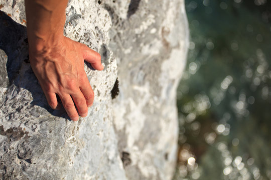 Female hand on rock