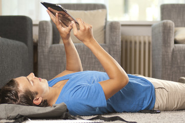 Young man is using a tablet computer