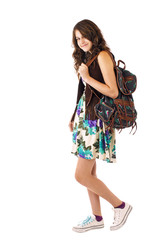 Teenage girl in flowered dress with backpack over shoulder