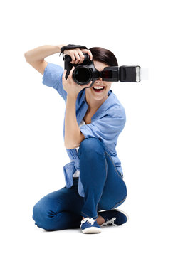 Woman-photographer takes images, isolated on a white