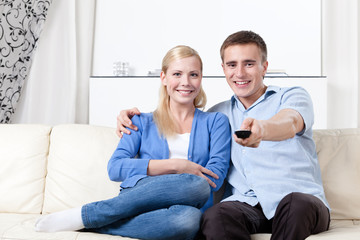 Sitting on the white leather sofa couple