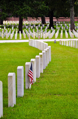 row of tombstones with american flag