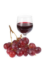 Glass of red wine with grapes