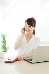 Beautiful business woman using a laptop computer. Portrait of as