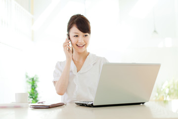 Beautiful business woman using a laptop computer. Portrait of as