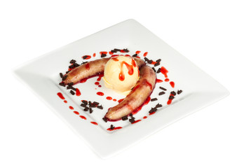 Bake banana with vanilla ice cream and caramel syrup; isolated o