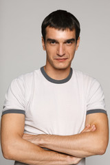 Young handsome male standing with folded hands