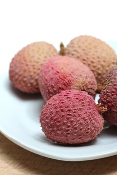 fresh lychees on a porcelain plate