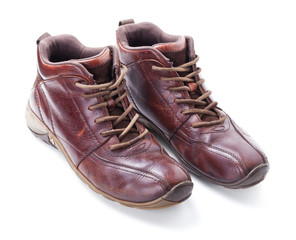 A pair of old brown boots isolated on white