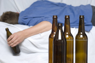 Man passed out with a beer bottle in his hand