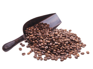 scoop with coffee beans scattered from it on white