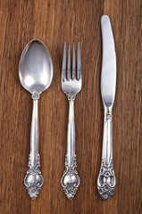 Retro cutlery set on wooden background