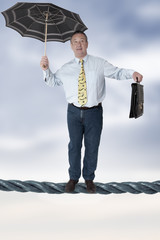 Business man balancing on the rope