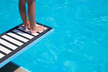 Boy, thrampoline and swimming pool