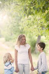 Fototapeta premium Smiling mother and little sons - family happiness