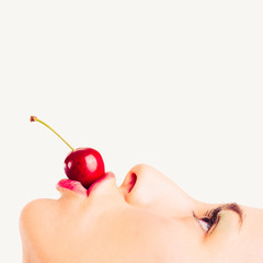 Close up portrait of beautiful young woman with cherry 