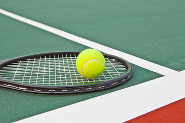 Tennis court with ball and racket