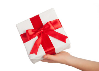 hand with a gift with a red ribbon isolated over white