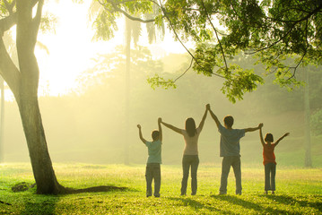an asian family jumping in joy