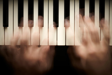 Hands playing piano. Motion blur