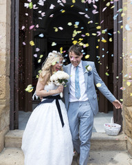 Confetti being thrown over the Bride and Groom