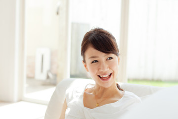 Beautiful young woman relaxing in the room. Portrait of asian.