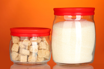 Jars with brown cane sugar lump and white crystal sugar