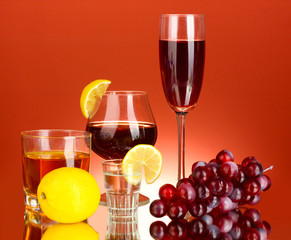 a variety of alcoholic drinks on red background