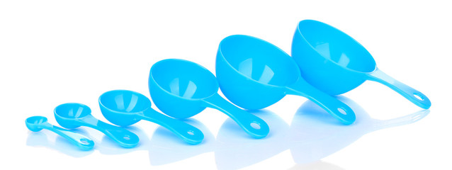 Blue measuring spoons isolated on white - obrazy, fototapety, plakaty