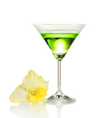 glass with cocktail and gladiolus bud isolated on white