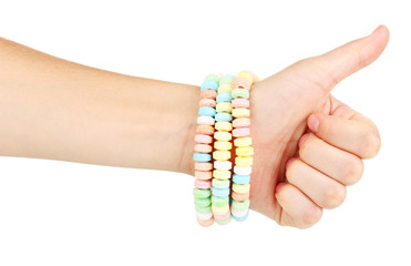 Color candies on hand isolated on white