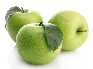 Ripe green apples with leaves  isolated on white