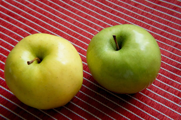 Close-up view of colorful apples on a red runner