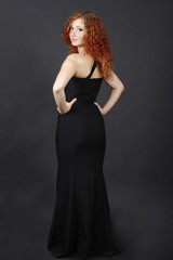 beautiful red-haired girl in a long black dress