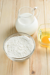 Obraz na płótnie Canvas Basic ingredients for dough. Milk, eggs and flour.