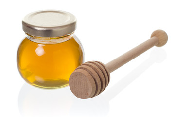 Jar of honey with dipper